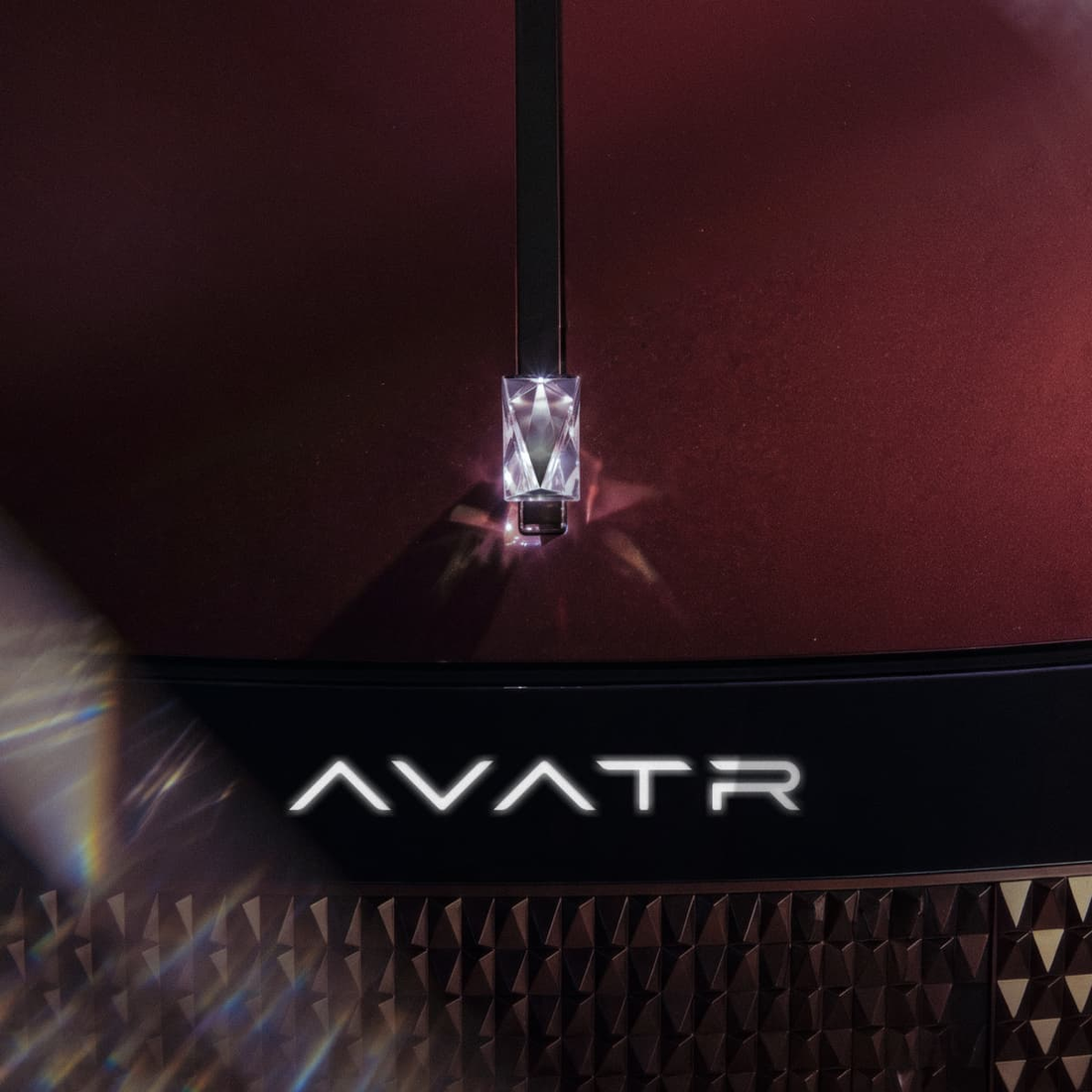 Avatr Concept T09 crystalline hood ornament above illuminated AVATR emblem and geometric grille — official concept design detail
